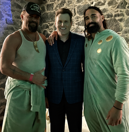 Photo of Hamilton magician Mick Peck performing magic for Jason Momoa at a corporate event